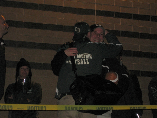 Coach Mac gets congratulatory hugs...
