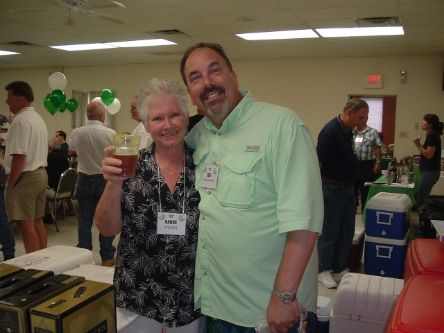 Nance Welch 62 gets a lesson on how to pour the perfect beer from Jeff Hoachlander 74