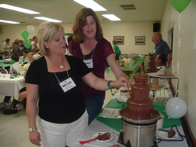 Mary Ellen McCauley Sierhuis 79 and Jennifer Ellam Starsinic 79 test out one of the chocolate fountains.